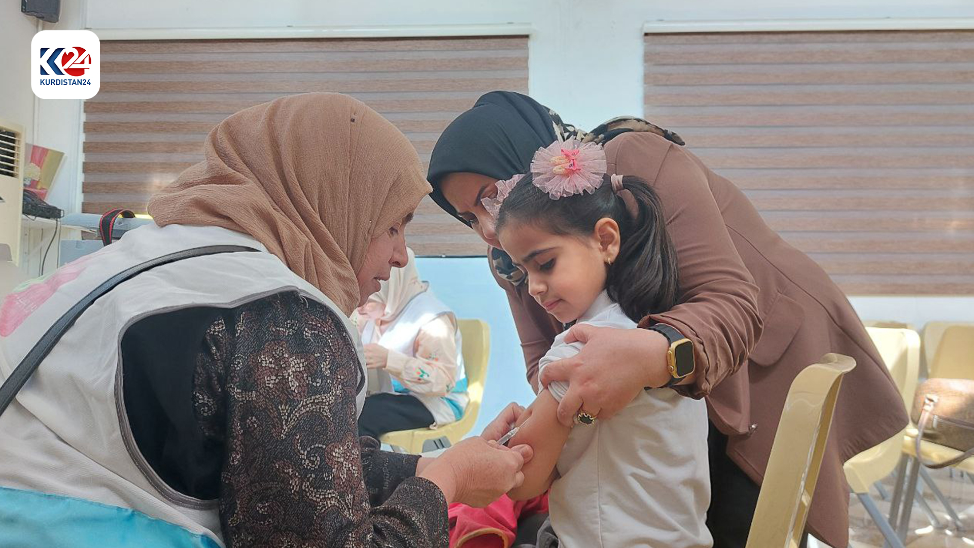 A nurse administrating the vaccine to a child.